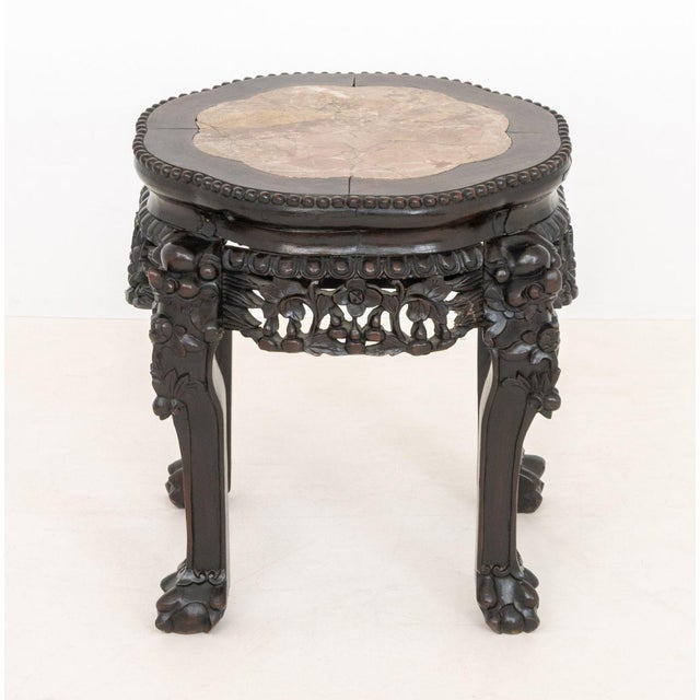 Chinese Red Marble Inset Hongmu Low Pedestal Table, the pierced apron carved with floral motif and legs terminating in paw...