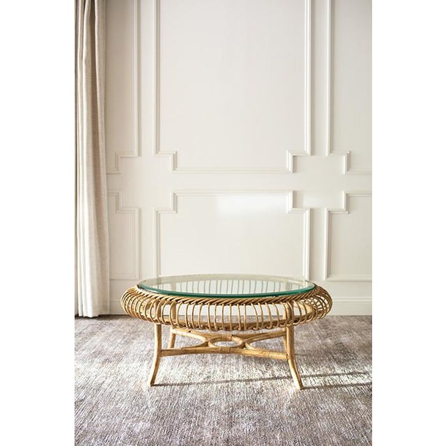 Bring an airy, tropical elegance to your living space with this striking round rattan coffee table. Crafted in the style...