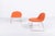3D designed by Komplot Design for Gubi is a chair with shell in HiRek upholstered in red orange fabric and sledge steel...