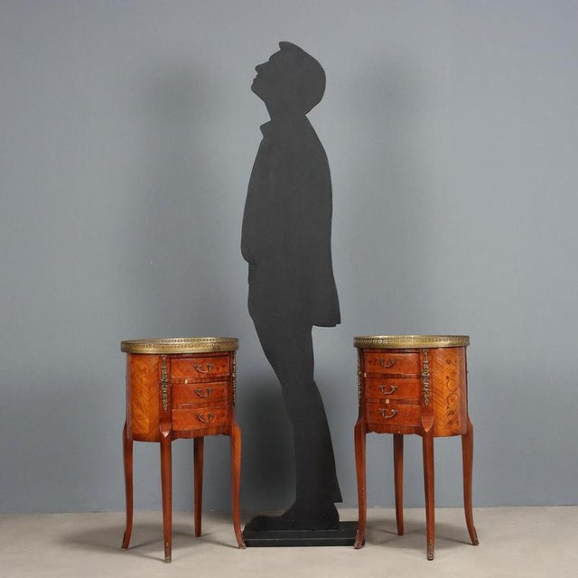 Pair of oval bedside tables, Napoleon III, in rosewood veneer. Floral inlays in various woods throughout, three drawer...