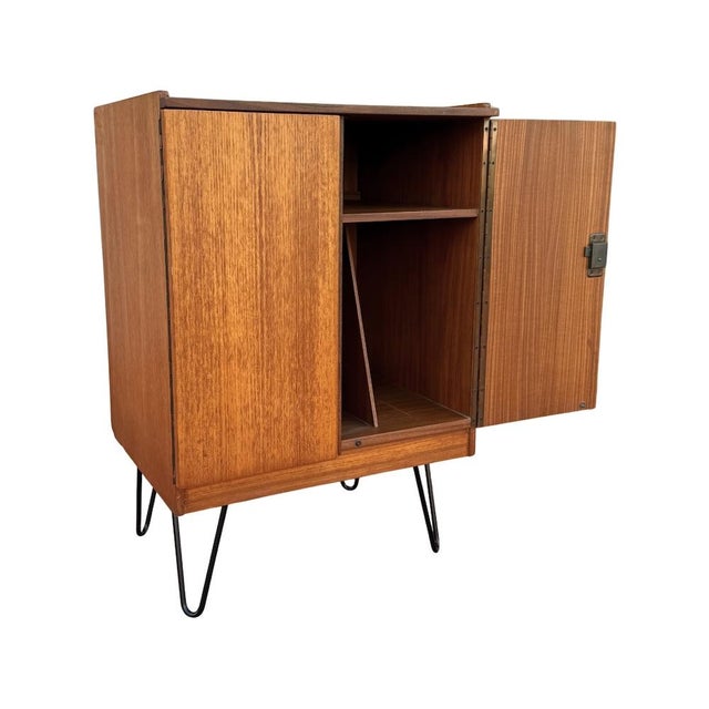 Vintage mid-century modern teak record storage cabinet by Dynatron UK. Features a locking cupboard with upper shelf for...