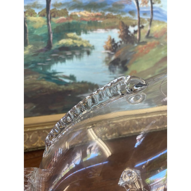 Style Attributed to Blenko Glass Company, this mid century hand-blown clear glass fish vase is a striking example of...
