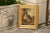 An English oil on canvas painting from the late 19th century depicting a boy sitting with his dog, in antique giltwood...
