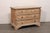 An Italian carved wood chest adorn with putti accents from the 18th century. This antique cassettiera (chest of drawers)...