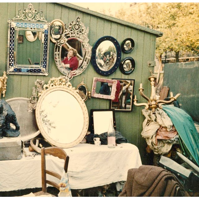 Paris Still Life A woman viewing items at a bric-a-brac stall on Boulevard Richard-Lenoir, Paris. From the series Paris in...
