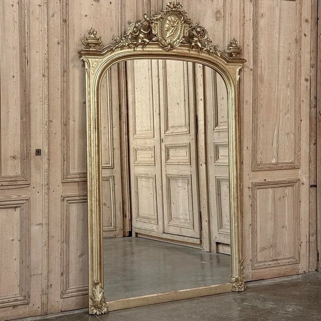 Grand 19th Century French Napoleon III Period Gilded Mirror is a magnificent example of the craftsmanship and artistry of...