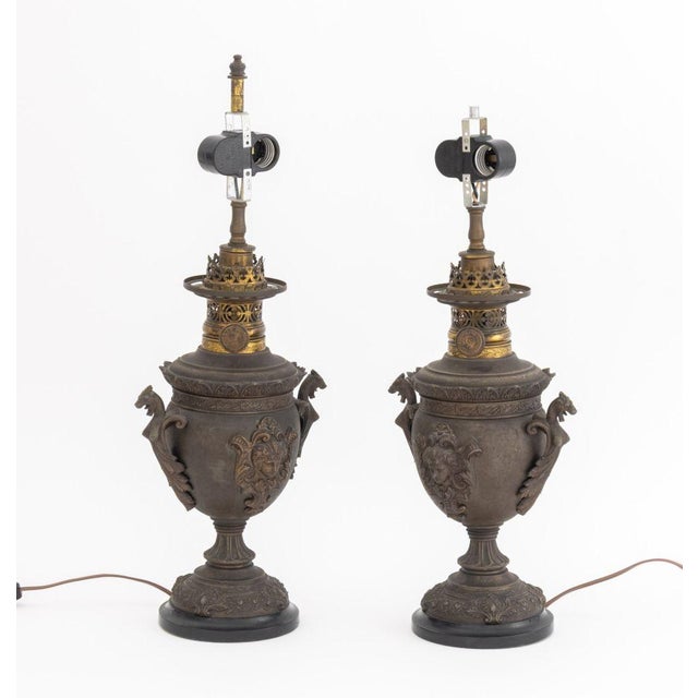 Pair of Neoclassical Two Handle Urn Lamps, dragon form handles, female mask head to center, marked "R. Ditmar /...
