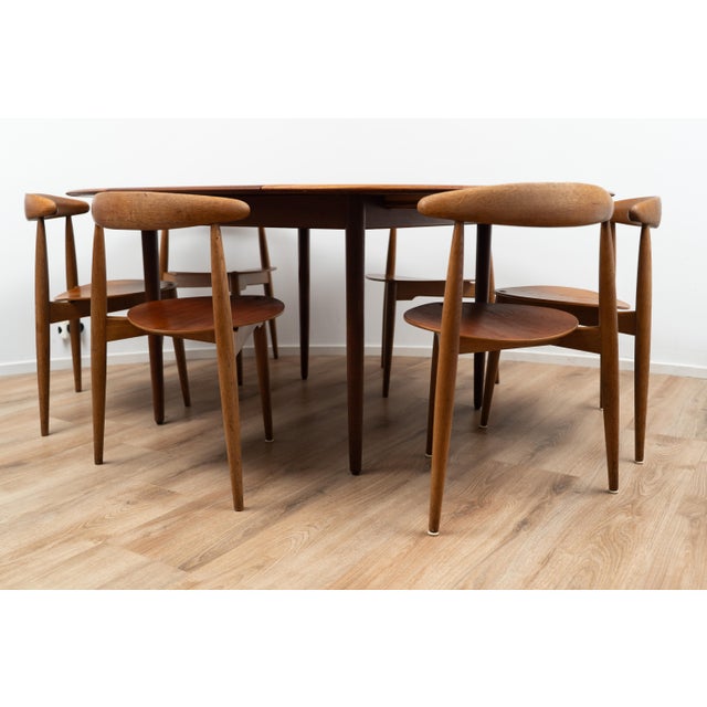 Dining Table & Chairs by Hans Wegner. This piece is entirely made out of wood and comes with six chairs. The table comes...