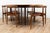 Dining Table & Chairs by Hans Wegner. This piece is entirely made out of wood and comes with six chairs. The table comes...