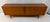 Beautiful Mid-Century Modern teak credenza featuring distinctive tambour doors that slide smoothly to reveal generous...