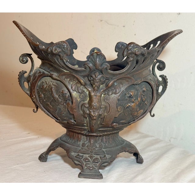 This antique Victorian figural bronze centerpiece jardiniere is a unique and ornate piece from the mid to late 19th...