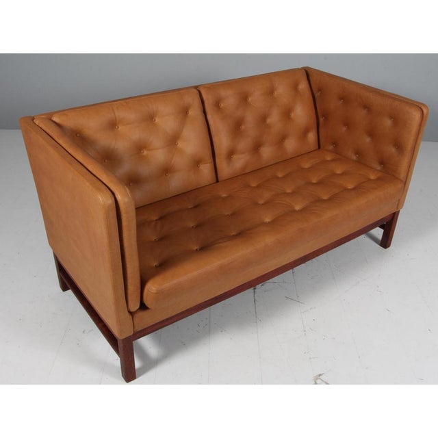 Erik Jørgensen two-seat sofa new upholstered with vintage tan aniline leather. Frame of mahogany. Model EJ 315/2, made by...