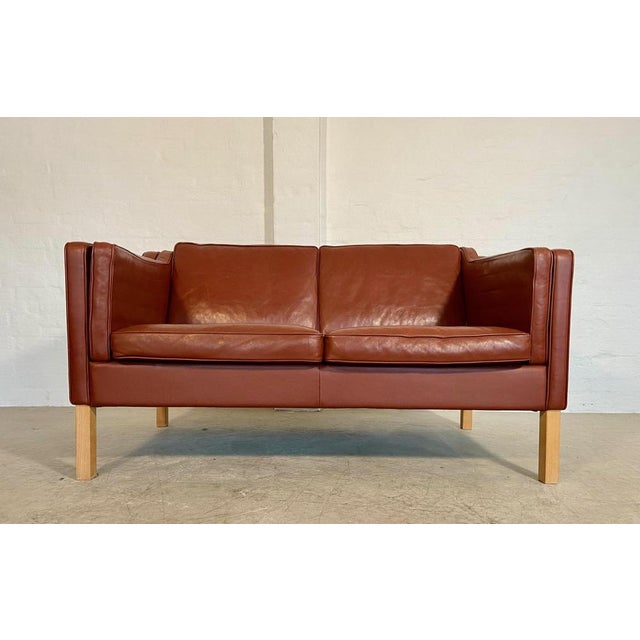 Made in Denmark by Mogens Hansen, this is a beautiful vintage Danish classic 2 person sofa which is upholstered in soft...