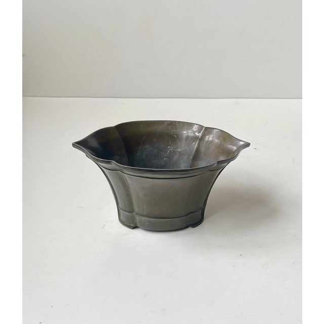 A wide diskometal vase with organic architectural lines. Designed and made by just andersen in denmark circa 1935-39....