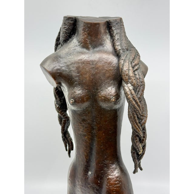 A wonderful bronze of a nude woman with long cornrows. It is solid cast and quite heavy. The sculpture is monogrammed on...