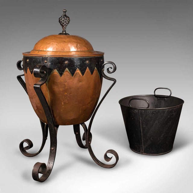 This is an antique Arts and Crafts fireside bin. An English, copper and wrought iron decorative coal or log keeper, dating...