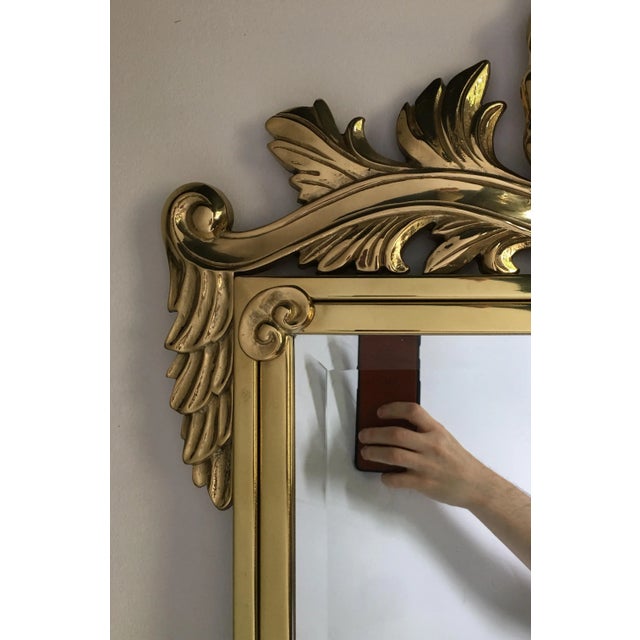 Large polished brass decorative wall mirror in the style of Mastercraft. Rectangular form with finely cast shell motif.