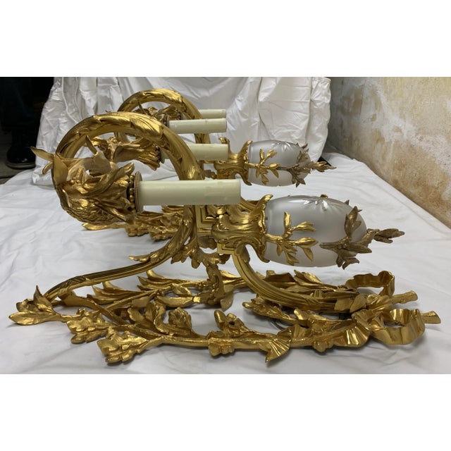 Early 20th Century French Regency style Gilt-Bronze 2-candle wall sconce.. Elaborate leaf and bow brass detail and etched...