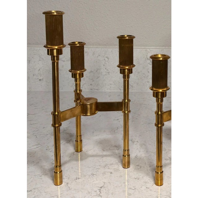 Pair of Vintage French Gilt Brass Candelabras. Each candelabra features three neoclassical style column candle holders.