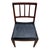 Handsome vintage wood side chair featuring a warm, dark-stained frame and a sleek black upholstered seat. The chair has a...