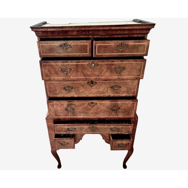 This is an antique Georgian style highboy or tall chest-on-stand in a beautifully figured burled walnut with outstanding...