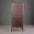 A bamboo cabinet in a dark brown finish, with two glass doors, each fitted with an X-strut bamboo motif at the top and...