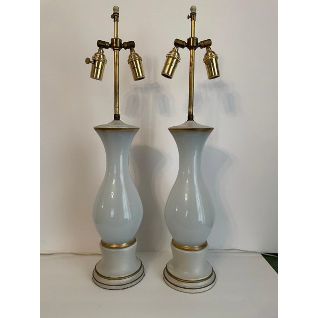 Pair Italian Opalescent glass lamps on gilt and painted bases. Two sockets each with adjustable shade rests. Rewired with...