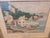 This original watercolor depicts a charming coastal village overlooking a tranquil harbor. The composition features softly...