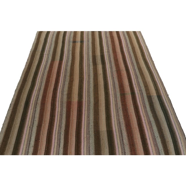 Handwoven in wool, a vintage Turkish kilim rug, connoting a rare variant of mid-century panel weaving styles circa...