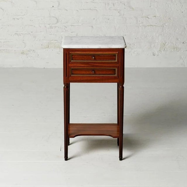 A beautifully intimate 19th century Belgian nightstand in the Louis XVI style, presenting a pristine white marble top...