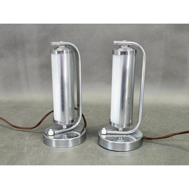 Elegant pair of art deco bedside lamps produced in czechoslovakia during the 1930s featuring nickel finish metal...