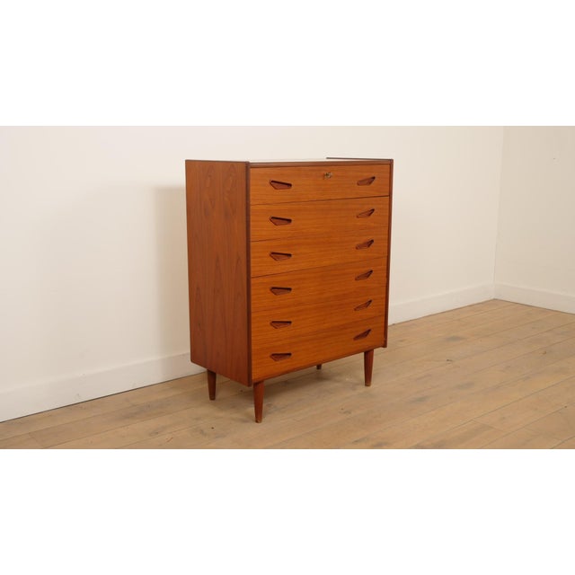 This stylish vintage chest of drawers is a magnificent example of Danish furniture from the mid-century period. Crafted...
