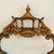 An ornate, vintage Chippendale style giltwood wall mirror featuring a pagoda top crest and figural bird accents along the...