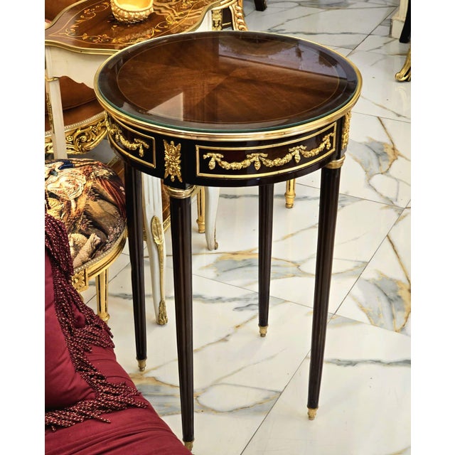 Bring timeless European elegance into your home with this handcrafted round accent side table. Built from durable solid...