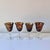 Vintage set of four blown tortoiseshell glass wine goblets with clear stems. The set has a bit of sparkle with copper...