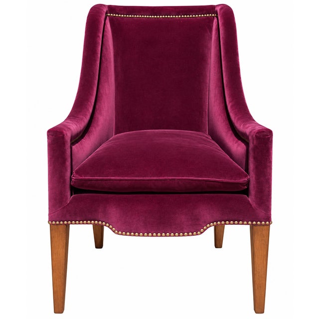 A striking pair of high-back armchairs upholstered in rich plum/burgundy velvet and finished with extensive brass-tone...