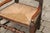An English William and Mary style oak youth chair from the late 18th century, with rush seat and spindle back. This...