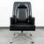 Vintage black vinyl executive chair. Sits on a metal rolling base. Unmarked example.
