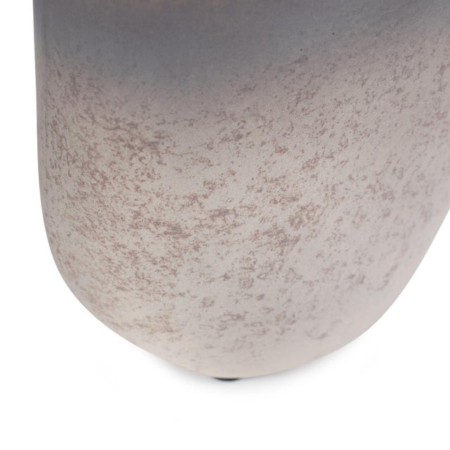 This hand-blown vase features a captivating ombre effect, blending cool gray and aubergine with warm beige and gold. With...