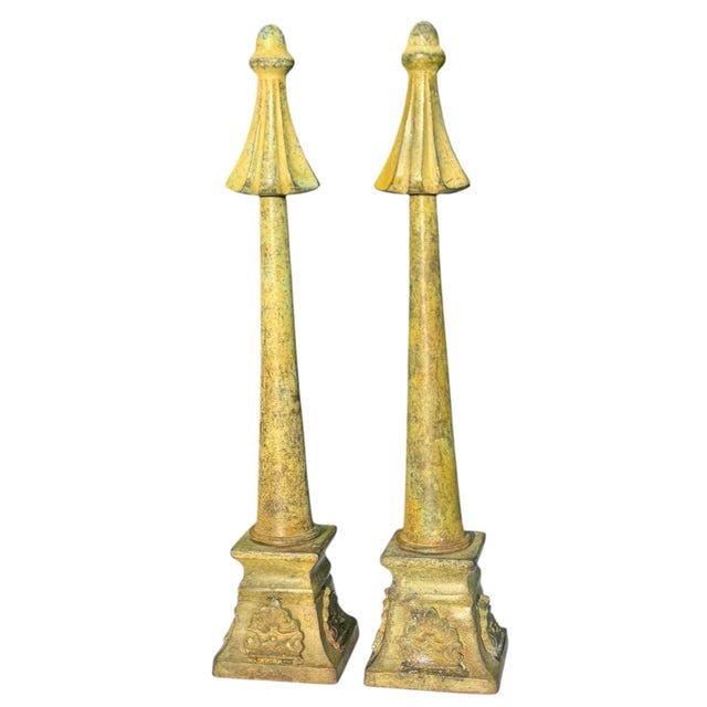 Striking vintage pair of substantial metal architectural ornaments with tall tapered forms, sculptural finial tops, and...