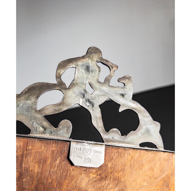 This bronze mirror from the 1920s was crafted by Oscar Antonsson for Ystad Tenn, a well-regarded Swedish metal workshop....