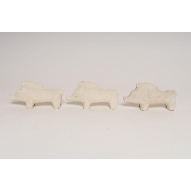 Set of three small ceramic boar sculptures with incised details designed by Aldo Londi for Bitossi (ca. 1960s, Italy)....