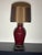 Show stopper high glam lamp from the 1980s. Dark berry red with brass swag detailing. Wired and working.