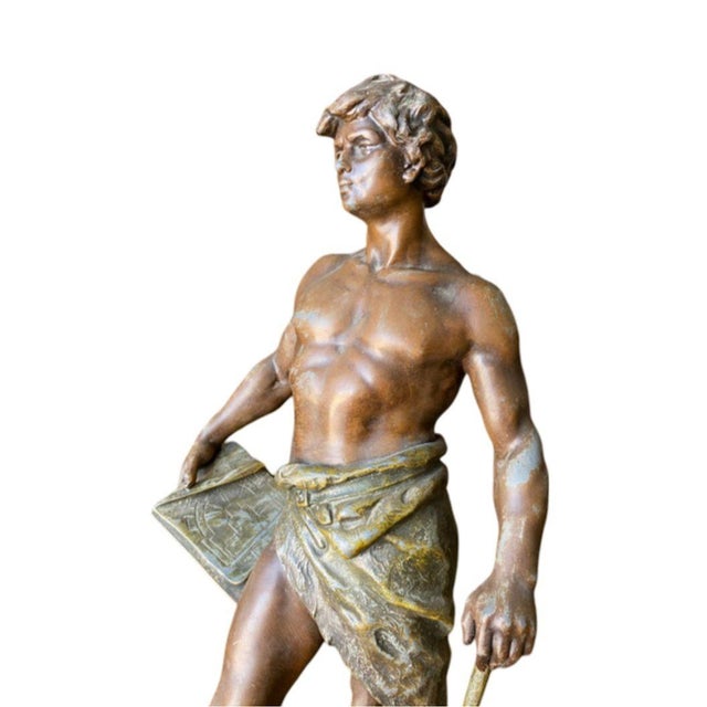 A beautiful masculine sculpture statue of a part clothed male entitled Francois Moreau, born 1857 at and died in 1930....