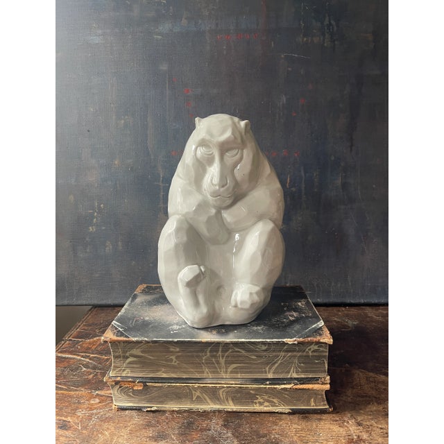 Stunning sculpture , all in a crisp white glaze, of a snow monkey sitting. Very sculpted and textured appeal. Lovely art...