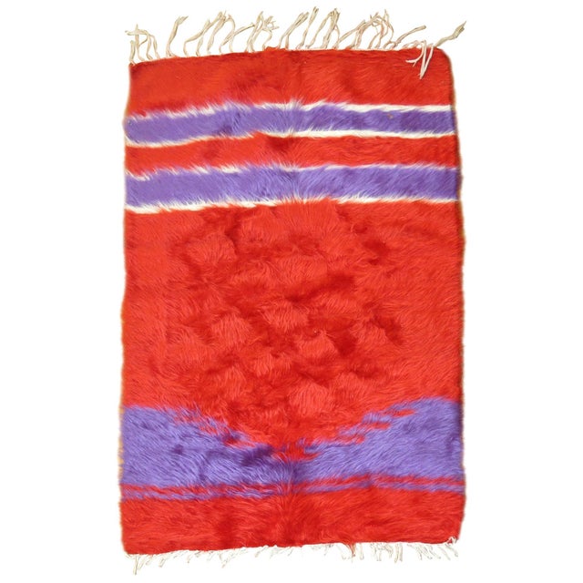 Rare color handwoven mohair wool rug in bright reds and purple. Measures: 2'6" x 3'8", third quarter 20th century.