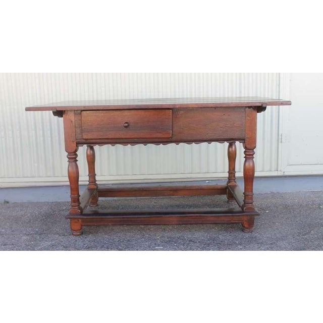 This 18th century Pennsylvania walnut tavern table is handmade nail and wood peg construction. It has wide three board top...