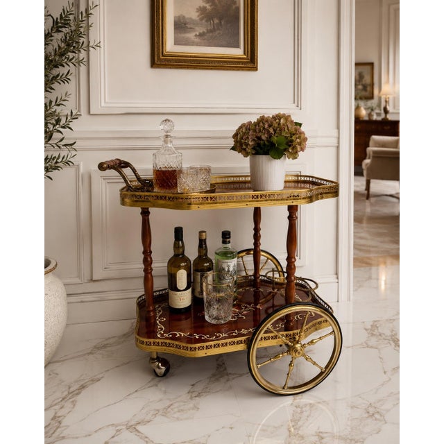 Elegant vintage two-tier tea and serving cart featuring warm mahogany-tone wood, decorative floral detailing, turned wood...