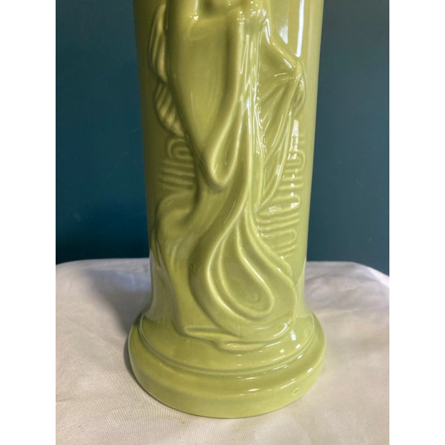 A striking vintage ceramic vase featuring a beautifully modeled relief image of an Asian woman dressed in flowing robes....