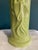 This striking vintage ceramic vase features a vibrant bright green glaze and an elegant embossed depiction of a Geisha...
